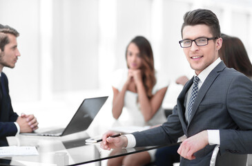 young businessman with his business team sitting at his Desk