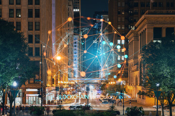 Chicago downtown area city view and Millennium Park, night time, Illinois, USA. Skyscrapers of financial district. Decentralized economy. Blockchain, cryptography and cryptocurrency concept, hologram