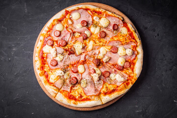 hot delicious traditional italian pizza on a dark stone background