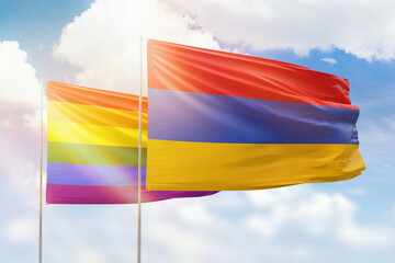Sunny blue sky and flags of lgbt and armenia