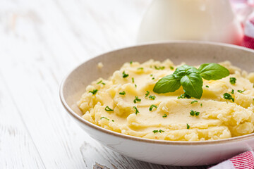 fresh tasty mashed potatoes on a white wooden rustic background