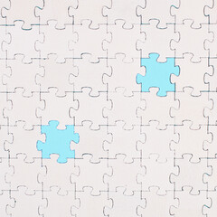 White jigsaw on a blue background, missing parts, working together as a team, searching for solutions, the last piece