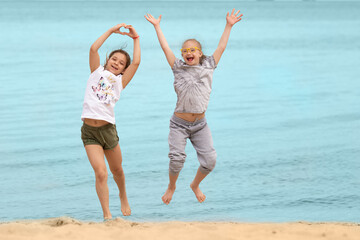 Girl with Down syndrome hugging her best friend on the beach