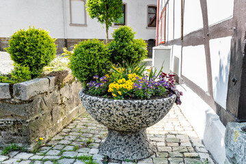Stone vase with spring flowers outdoors