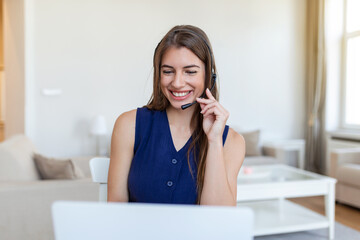 young call centre agent working in an office. Portrait of a cheerful young businesswoman talking on a headset to clients while working inside of the office