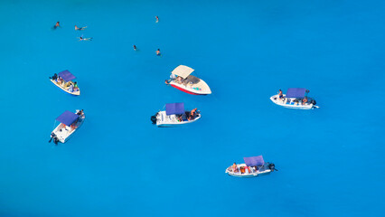 A boat in the lagoon. View of the sea bay and a lone boat from a drone. Blue sea water. Vacation and travel. Summer landscape from the air.