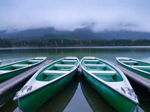 Boats on the Hintersea lake, Germany. Landscape during fog. Lake and trees. Rental boats. High-resolution photo