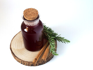 Tonic for face and hair, rosemary water with cinnamon. Green branches of rosemary and brown...