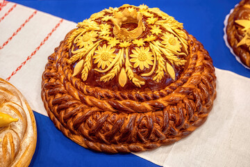 Traditional ukrainian wedding bread on an embroidery towel. Round loaf wedding bread.