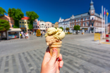 Pistachio and coffee ice cream in a cone on the market square in Puck. Poland