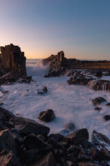 Wave water flowing between rocks at Bombo Quarry, Australia.