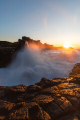 Sunrise view with breaking wave at Bombo Quarry, Australia.