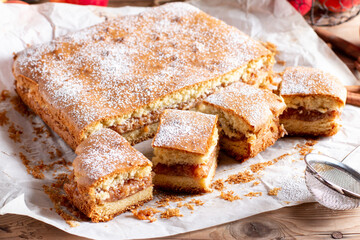 Clasic sponge cake, selective focus. Homemade pie on wooden background