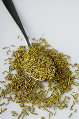 fragrant dried rosemary on a white acrylic background