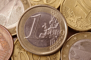 one euro coin on top of other coins