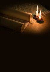 Ancient scroll lit by candlelight