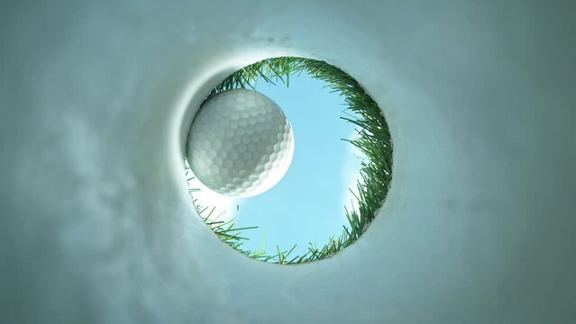 Super slow motion of golf ball falls into the hole at the camera, view inside the hole close-up. Filmed on high speed cinematic camera at 1000 fps.