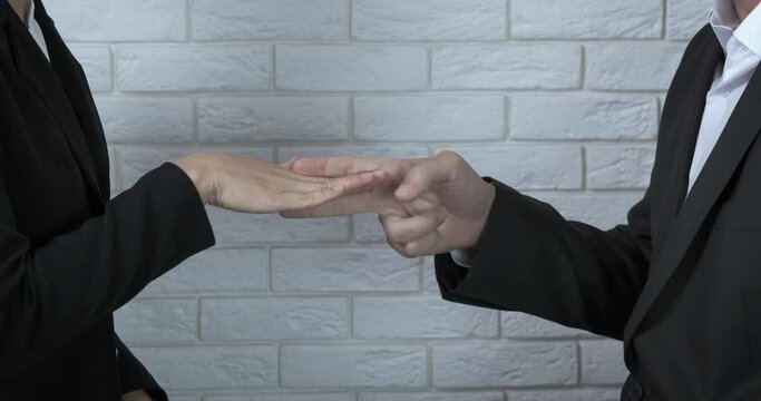 Argue with fists. A view of a man and woman fists play rock paper scissors game.