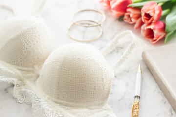 Women's underwear, tulips and other women's fashion accessories on the table