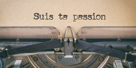 Text written with a vintage typewriter - Follow your passion in french - Suis ta passion