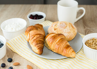 Healthy breakfast. Croissants, buns, cottage cheese, berries and fruits and berries