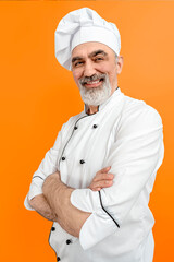 Chef-cooker in a chef's hat and jacket. Senior professional baker man wearing a chef's outfit. Character kitchener, pastry chef for advertising.