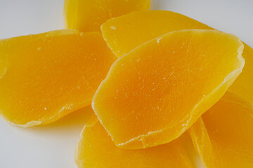 delicious dried mango on a white acrylic background