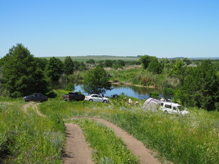 Adventures Camping tourism and tent and car next to the lake. Landscape outdoor