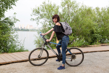 Girl tourist on a bicycle stopped to rest.