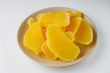 delicious dried mango on a white acrylic background