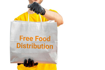 Free Food Distribution. Volunteer carrying food donation box. Young smiling man wearing uniform cap...