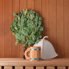 Birch broom, mug and hat on the shelf in the bath. Health and Clean Concept