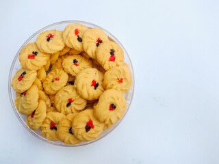 Cookies in a bowl. Sagu keju or kue sago or kue semprit keju with strawberry jam on top. Indonesian butter cookies. These cookies commonly served for Idul Fitri or Lebaran The Great Islamic Day