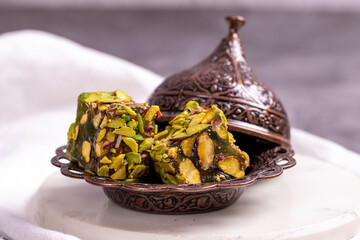 Turkish Delight with Pistachio on a dark background. Traditional Turkish delicacies. Turkish Delight with Apple Flavored Pistachio. close up