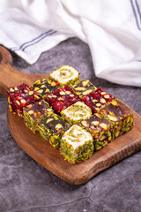 Turkish delight on a dark background. Traditional Turkish delicacies. Varieties of Turkish Delight with Pistachio. close up