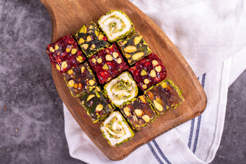 Turkish delight on a dark background. Traditional Turkish delicacies. Varieties of Turkish Delight with Pistachio. close up