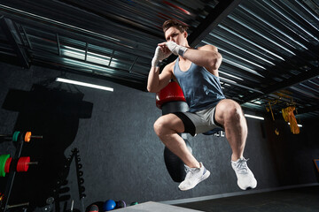 Fototapeta na wymiar Professional sportsman doing plyometric exercise at gym