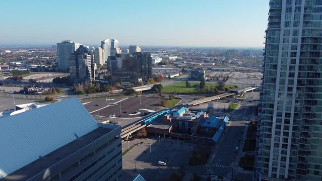 Urban city center intensification development with sky train, buses, shopping centre, residential condos and commercial real estate; aerial drone 4K