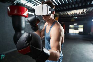 Sporty man practicing punches in virtual reality