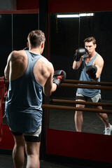 Determined young male athlete practicing at gym