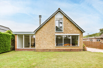 Backyard of house with grassy lawn
