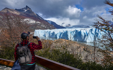tourist posing for a photo on the Perito Moreno glacier, in Patagonia Argentina