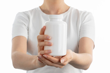 Close up image of woman holding a white bottle