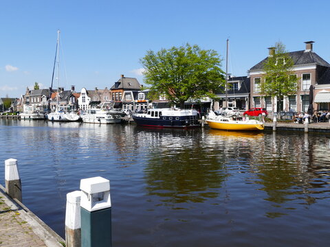 Yachts at the quay of the canal through (Dutch) Lemmer (Frisian) De Lemmer (port town on the Ijsselmeer, a very big lake), Friesland, Netherlands