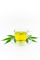 Hemp herbal tea, Hot Hemp in a glass cup with tea leaves on white background.