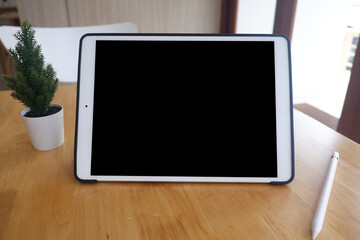 Mockup picture of business woman’s hands using tablet with white blank screen in modern place