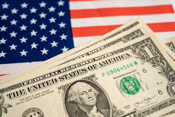 US dollar banknotes money on USA America flag, finance banking concept.