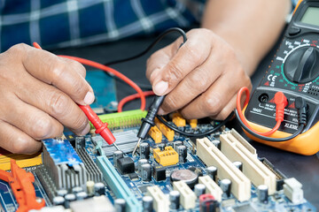 Technician repairing inside of mobile phone by soldering iron. Integrated Circuit. the concept of...