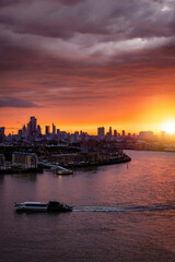 Naklejka premium A spectacular sunset behind the modern skyline of London and river Thames during summer time, England