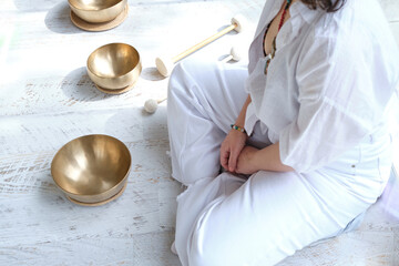 Sound healing meditation with singing bowls, a woman meditating